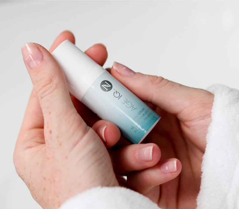 Woman holding Neora’s wrinkle-reducing Age IQ® Eye Serum in her hands